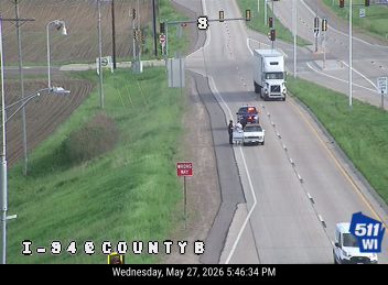 Police and tow truck at roadside incident on I-94 near County B.