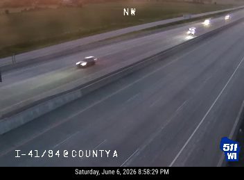 Emergency vehicles are present on the highway, indicating a possible incident.