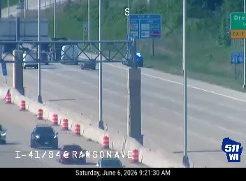 Emergency vehicle with flashing lights on the highway shoulder.