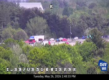Emergency responders and vehicles on the highway with traffic stopped.