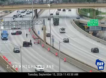 Construction cones and workers in the left lane