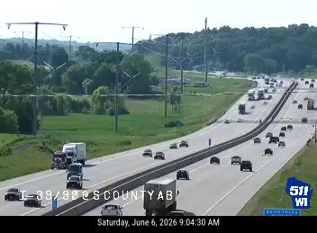 Fire truck and emergency personnel on the shoulder of the highway.