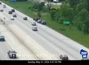 Multiple vehicles stopped in lanes, appearing to be a multi-car accident.