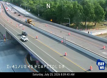 Construction cones and workers in the right lane