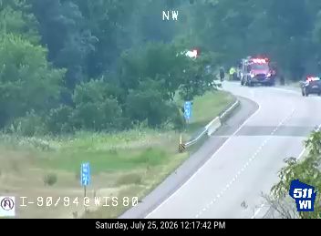 Fire truck and police car with lights on the shoulder