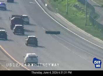 A large tire is in the roadway, obstructing traffic.