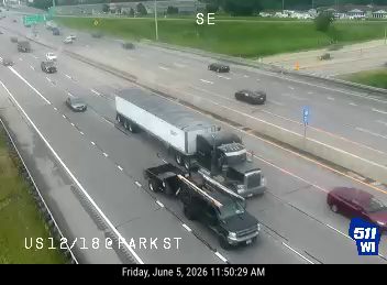 Emergency vehicle and tow truck on the shoulder of the highway.