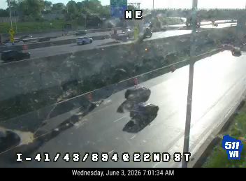 Large debris, possibly rocks, on the roadway causing a lane obstruction.