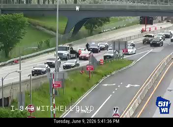 Emergency responders and vehicles are present on I-94 Mitchell Blvd, indicating an incident.