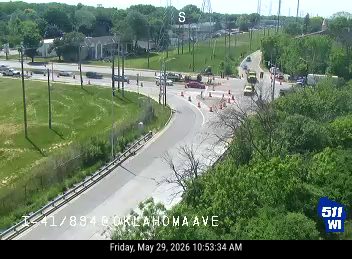 Emergency vehicles and cones indicate a responder incident on the roadway.
