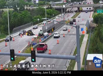 Construction vehicles and cones indicate ongoing road work or an incident response.