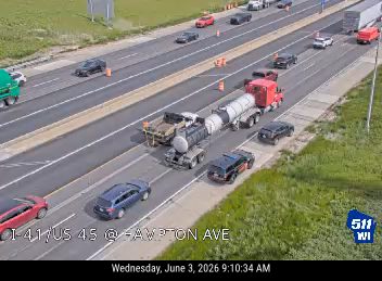 Emergency vehicles and a tow truck appear to be responding to an incident on the highway.