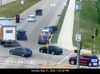 Police officers are present at a scene with stopped vehicles.