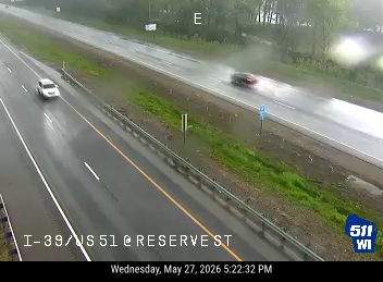 Two vehicles appear to be involved in a crash on a wet roadway.