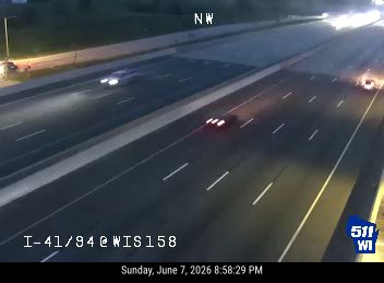 Vehicle appears to have crashed on the right shoulder, with debris and smoke visible.