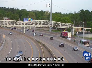 Emergency responders and a bus are stopped on the shoulder of the highway.