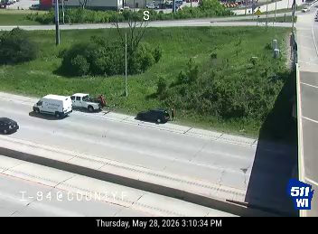 Two vehicles appear to be involved in a crash on the side of the road.