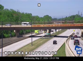 Emergency vehicles and personnel on the roadway under the overpass.