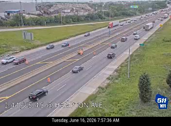 Construction cones and a worker in the left lane