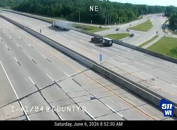 Car overturned on highway, blocking lanes.