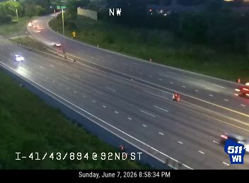 Emergency responders and vehicles on the highway, possibly at an incident scene.