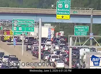 Emergency vehicle and traffic stopped on highway, indicating an incident.