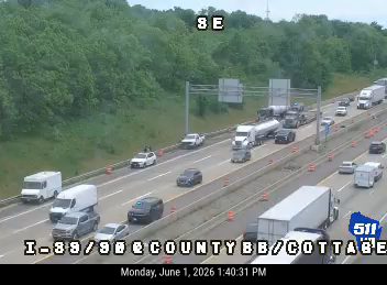 Emergency responders and vehicles are present on the highway shoulder.