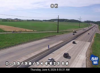 Maintenance truck and trailer on the shoulder, possibly responding to an incident.