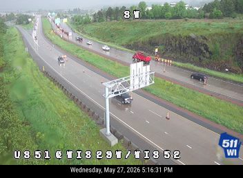 Multiple vehicles stopped on highway, red truck appears to be involved in a crash.