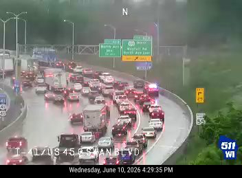Emergency vehicle with flashing lights in traffic, likely responding to an incident.