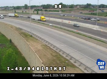 Emergency responders and vehicles are present on the highway shoulder.