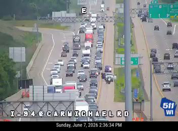 Multiple vehicles stopped in traffic lanes, indicating a possible crash.