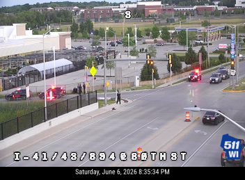 Emergency responders and vehicles are present at a roadside incident.