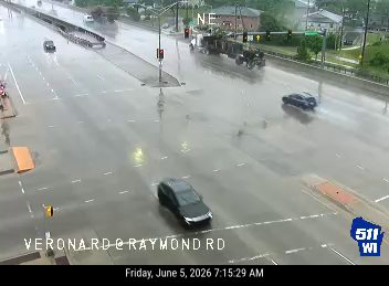 Roadway is flooded with standing water, affecting traffic flow.