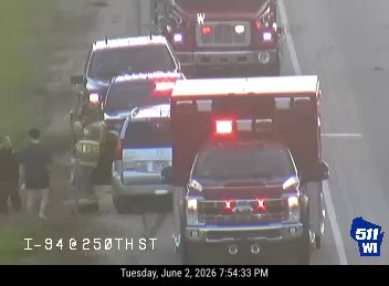 Emergency responders and vehicles on the roadway, likely at an incident scene.