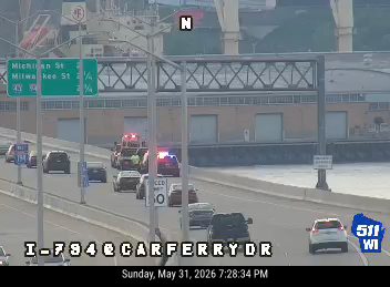 Emergency responders with lights on are present on the roadway.