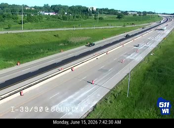 Construction cones and fresh asphalt in the left lane