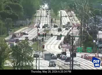 Emergency vehicles and cones on the roadway, indicating a responder incident.