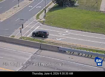 Tow truck and personnel attending to a vehicle on the side of the road.