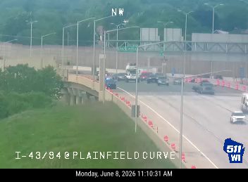 Police and other vehicles on the highway, possibly responding to an incident.