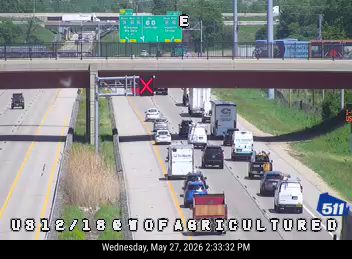 Multiple vehicles involved in a crash on the highway, blocking lanes.