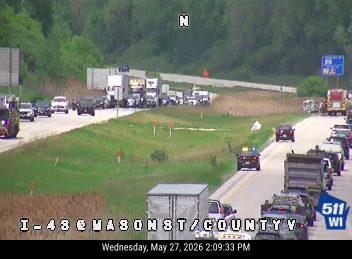 Emergency vehicle on scene with traffic stopped on the highway.