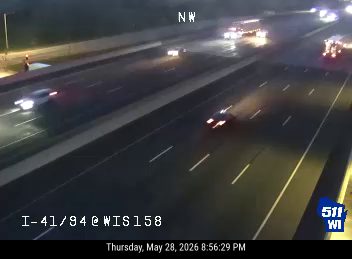 Emergency vehicles are present on the highway, possibly responding to an incident.