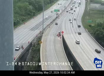 Emergency vehicle and cones on the right shoulder of I-94 at Stadium Interchange.