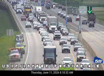 Emergency vehicle with lights on in traffic, indicating a possible incident ahead.