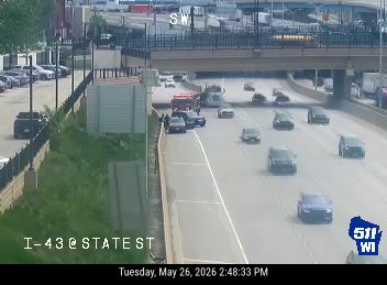 Emergency responders and vehicles are present on the side of the highway.