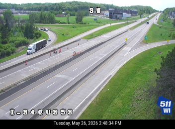 Emergency responders and cones on the highway shoulder, possibly directing traffic.