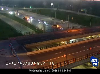 Multiple emergency vehicles and personnel on the roadway, possibly responding to an incident.