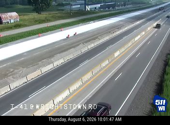 Construction cones and workers in the left lane