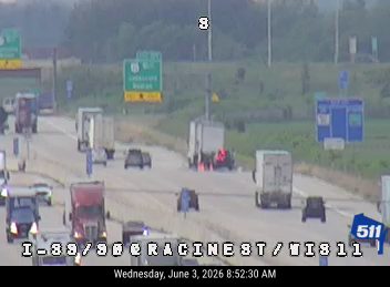Police and emergency vehicles on the highway, traffic is stopped.